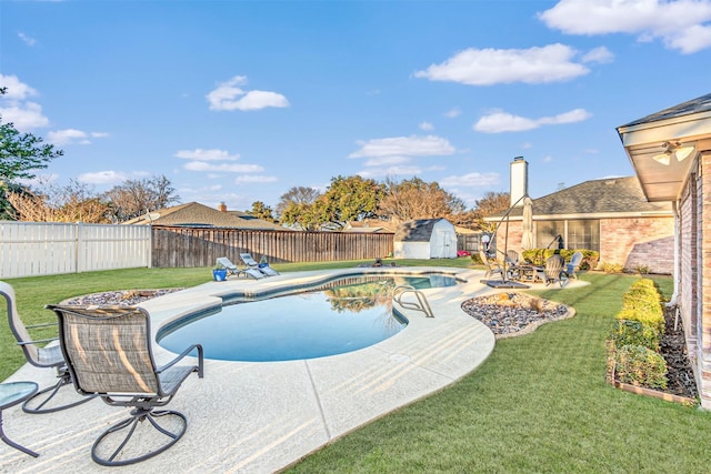 view of swimming pool featuring a lawn, a storage unit, and a patio