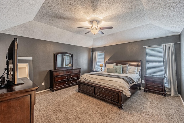 carpeted bedroom featuring ceiling fan and vaulted ceiling