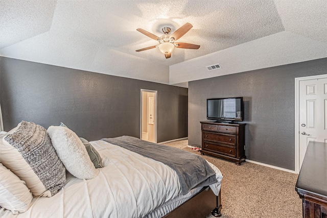 bedroom with light carpet, ceiling fan, vaulted ceiling, and a tray ceiling