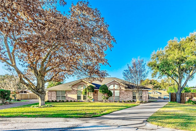 ranch-style home with a front yard