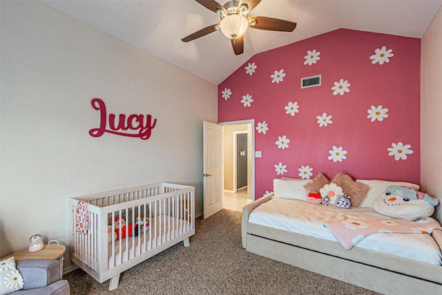 bedroom featuring ceiling fan, a nursery area, carpet flooring, and lofted ceiling