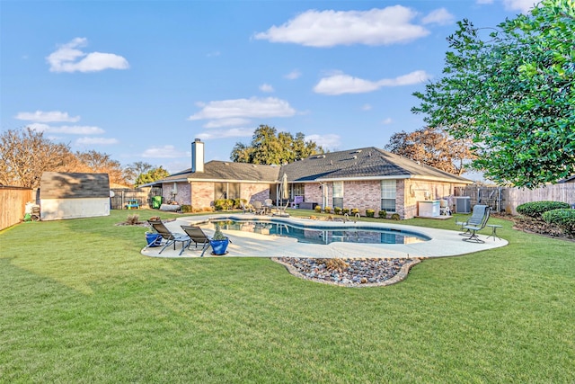 view of pool featuring a storage shed, central AC unit, a patio, and a yard