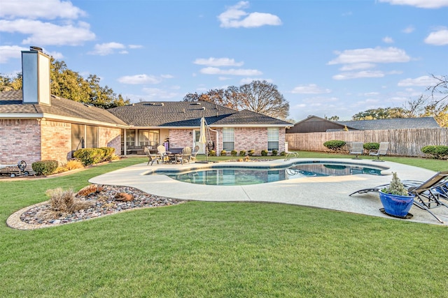 view of pool with a patio area and a yard