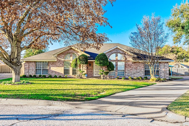 single story home featuring a front yard