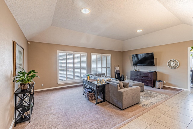 living room with a raised ceiling, light tile patterned floors, a textured ceiling, and lofted ceiling