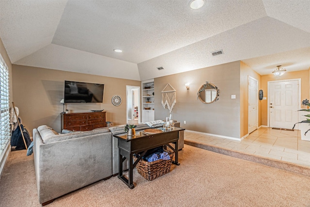 living room with vaulted ceiling, light colored carpet, and built in shelves