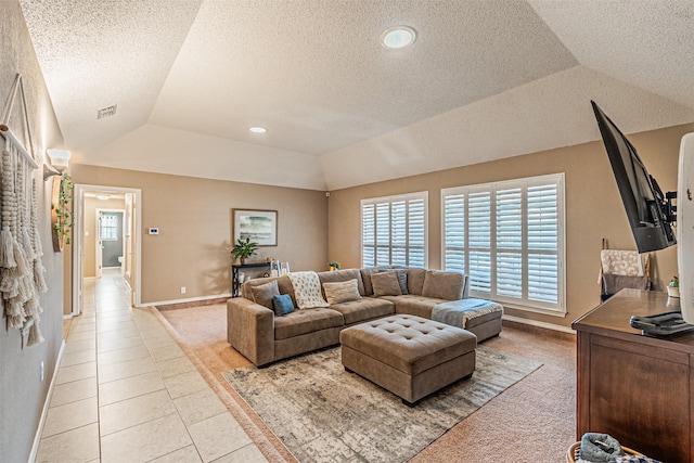 tiled living room with a textured ceiling, a tray ceiling, and lofted ceiling