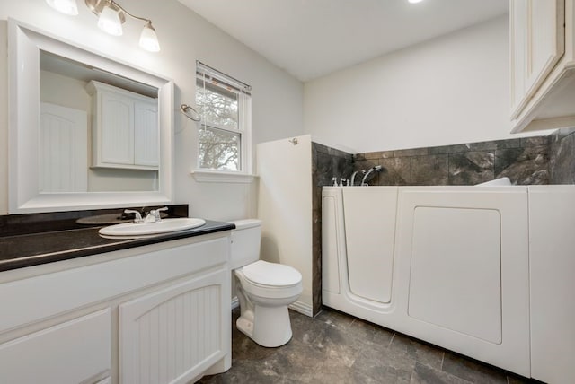 bathroom featuring vanity and toilet