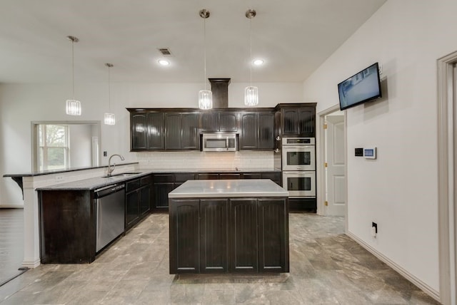 kitchen with appliances with stainless steel finishes, tasteful backsplash, sink, hanging light fixtures, and kitchen peninsula