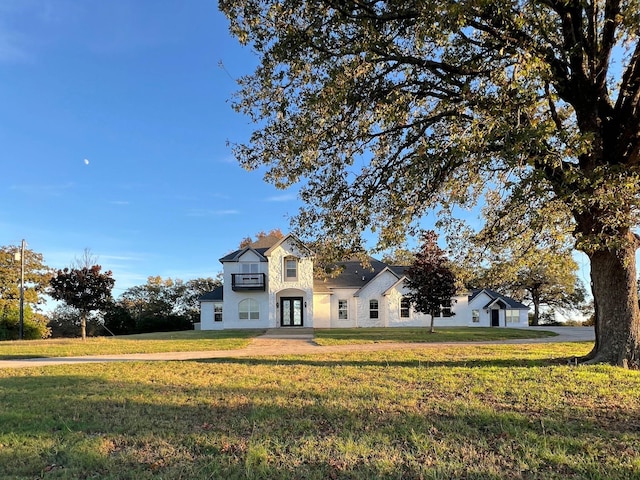 view of front of house featuring french doors and a front lawn