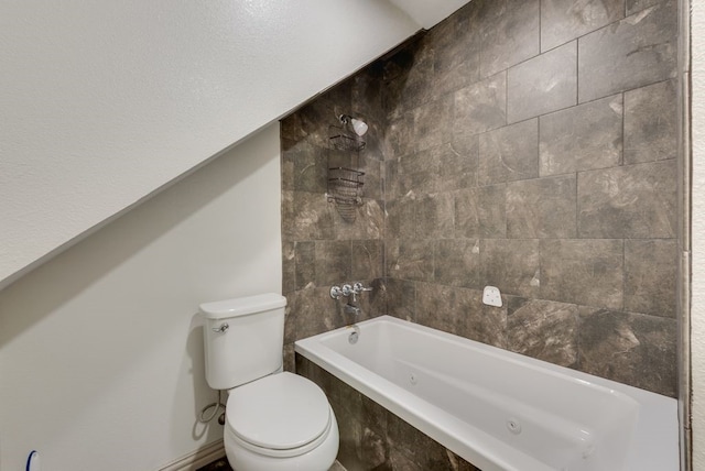 bathroom featuring toilet and tiled shower / bath combo