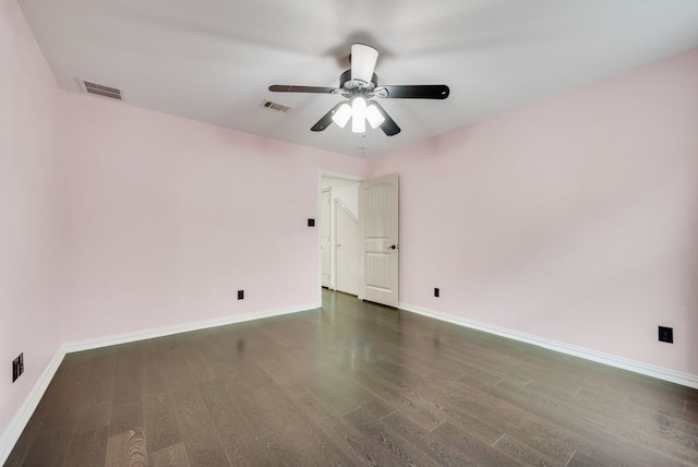 empty room with dark hardwood / wood-style flooring and ceiling fan