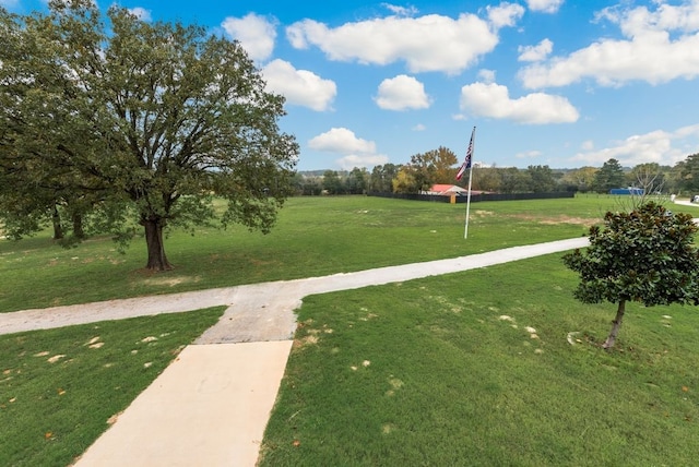 view of property's community with a lawn