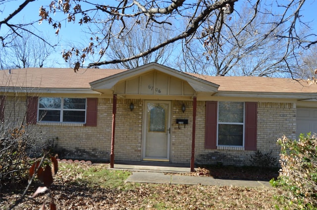 doorway to property with a garage