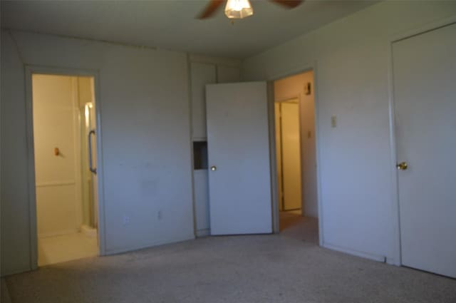 unfurnished bedroom with ceiling fan and ensuite bathroom