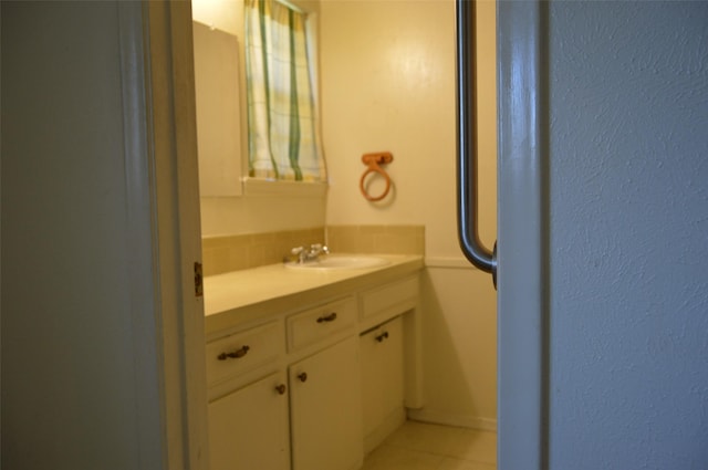 bathroom with tile patterned flooring and vanity