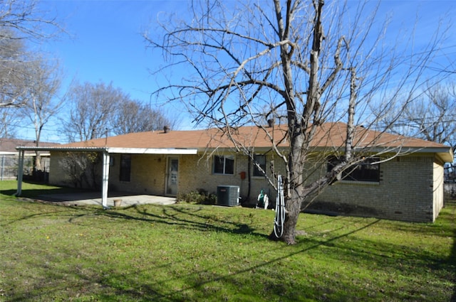 back of property featuring a lawn, a patio area, and central AC unit