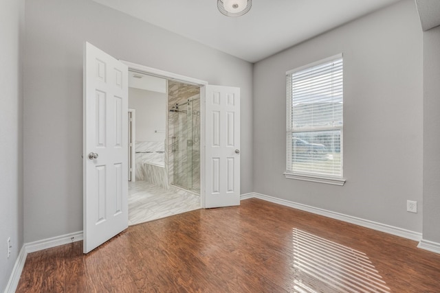 unfurnished bedroom with wood-type flooring