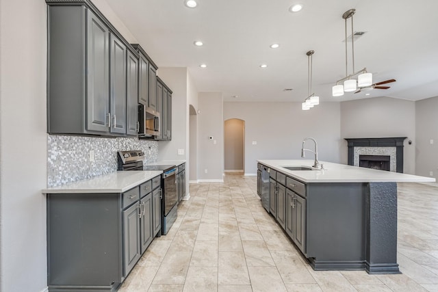 kitchen featuring gray cabinetry, pendant lighting, sink, ceiling fan, and stainless steel appliances