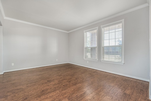 empty room featuring dark wood-type flooring and crown molding