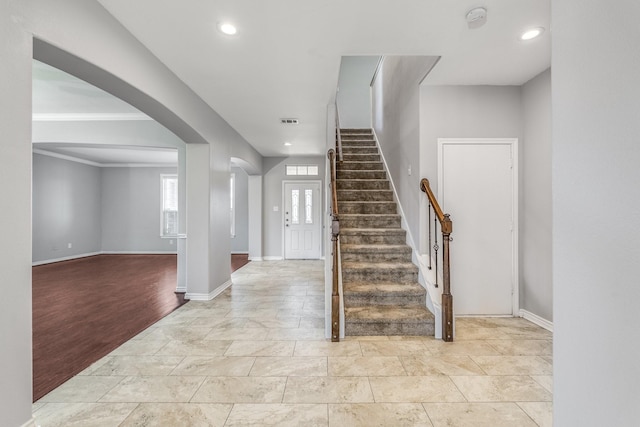 entrance foyer featuring light wood-type flooring and ornamental molding