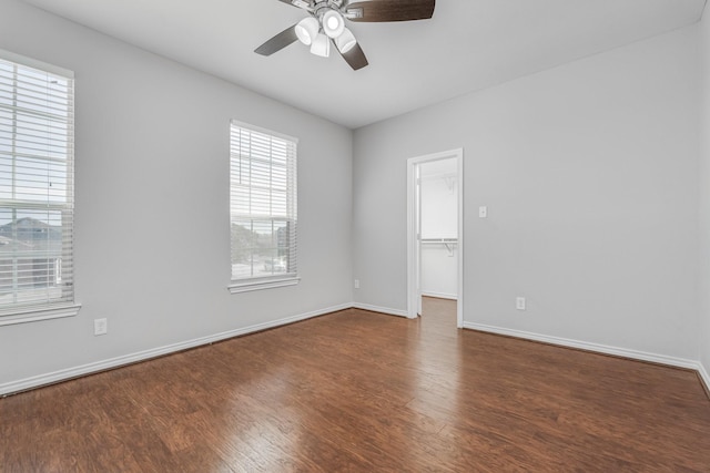 spare room featuring dark hardwood / wood-style floors and ceiling fan