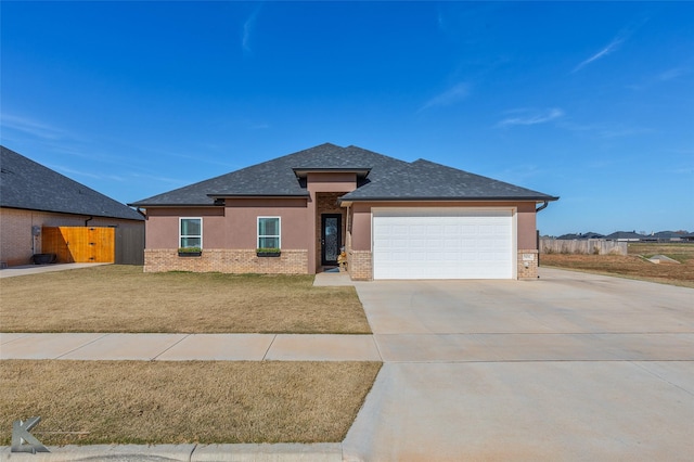 view of front of property with a garage and a front lawn