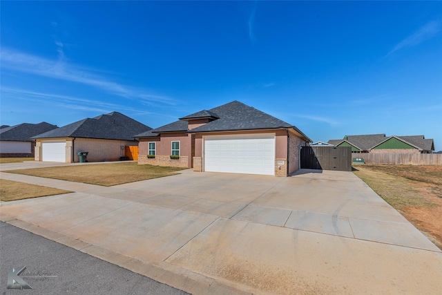 prairie-style home featuring a front lawn and a garage