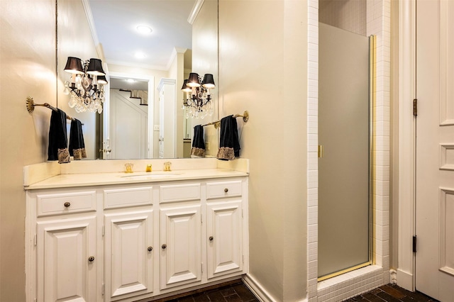 bathroom featuring crown molding, vanity, and walk in shower