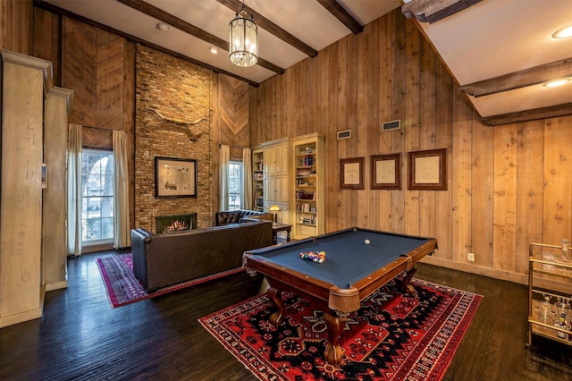 recreation room featuring dark wood-type flooring, a fireplace, pool table, wooden walls, and beam ceiling