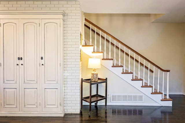 stairway featuring wood-type flooring