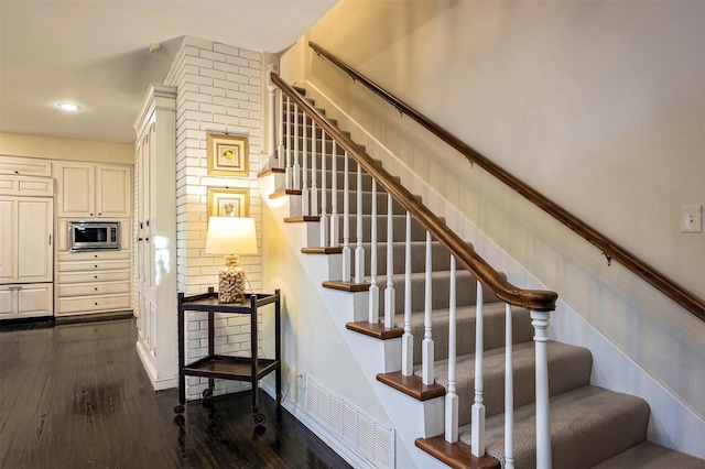 stairway featuring hardwood / wood-style floors