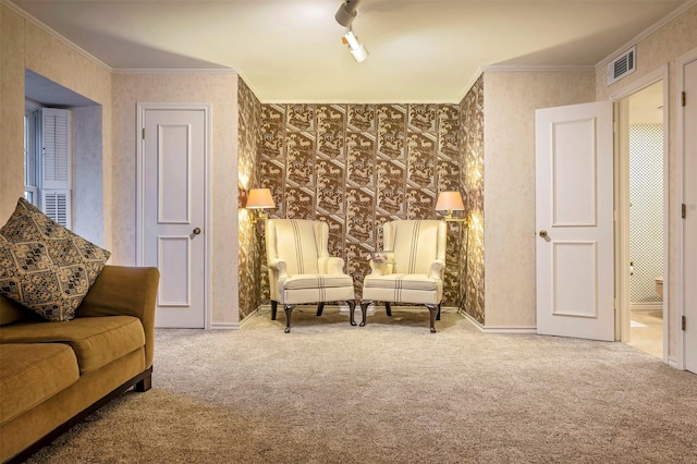 living area featuring ornamental molding and carpet flooring