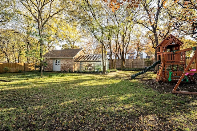 view of yard featuring an outdoor structure and a playground