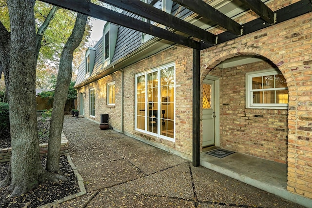 view of side of home featuring a pergola and a patio