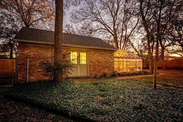 view of back house at dusk