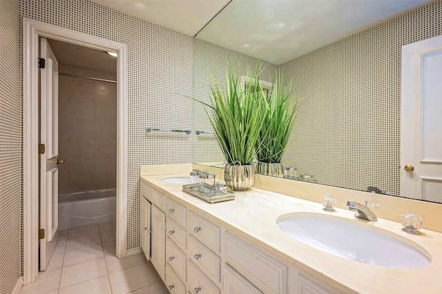 bathroom featuring tile patterned flooring, vanity, and tiled shower / bath