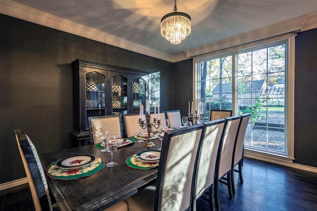 dining room with ornamental molding, a healthy amount of sunlight, dark hardwood / wood-style flooring, and a notable chandelier