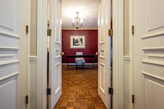 corridor with an inviting chandelier, ornamental molding, and dark parquet floors