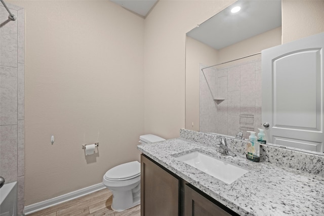 bathroom with wood-type flooring, vanity, and toilet