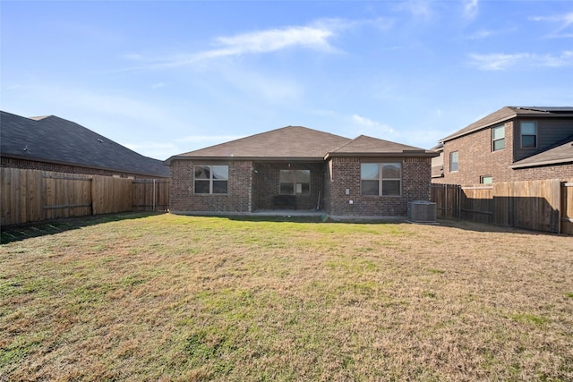 rear view of property with a lawn