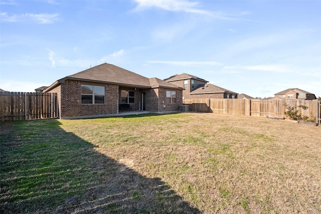 rear view of house with a yard