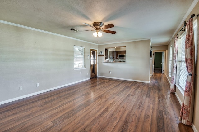 unfurnished living room featuring dark hardwood / wood-style flooring, ornamental molding, and a wealth of natural light