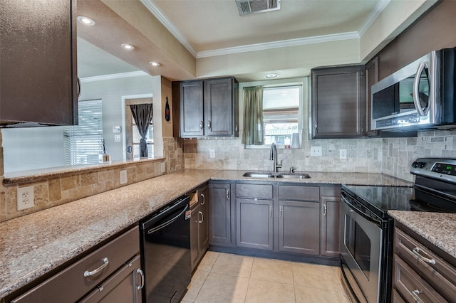 kitchen featuring backsplash, sink, appliances with stainless steel finishes, light tile patterned flooring, and light stone counters