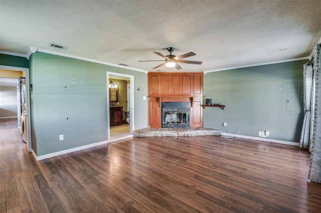 unfurnished living room featuring ceiling fan, a large fireplace, dark hardwood / wood-style floors, a textured ceiling, and ornamental molding