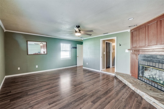 unfurnished living room featuring a textured ceiling, dark wood-type flooring, ceiling fan, and ornamental molding