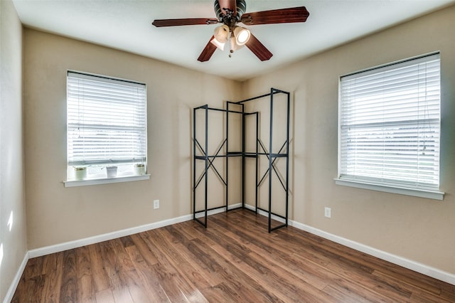 unfurnished room with dark hardwood / wood-style floors and ceiling fan