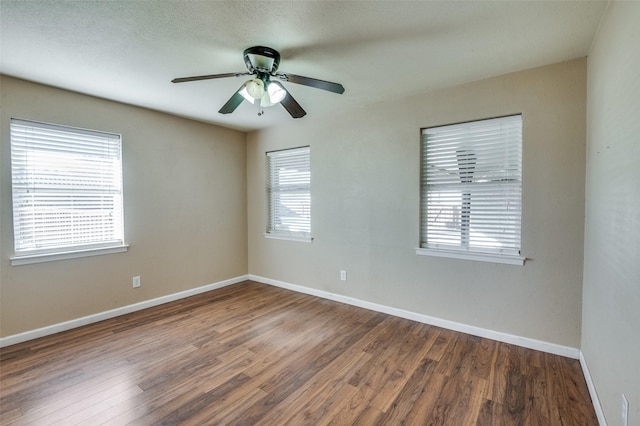 spare room featuring ceiling fan and dark hardwood / wood-style floors