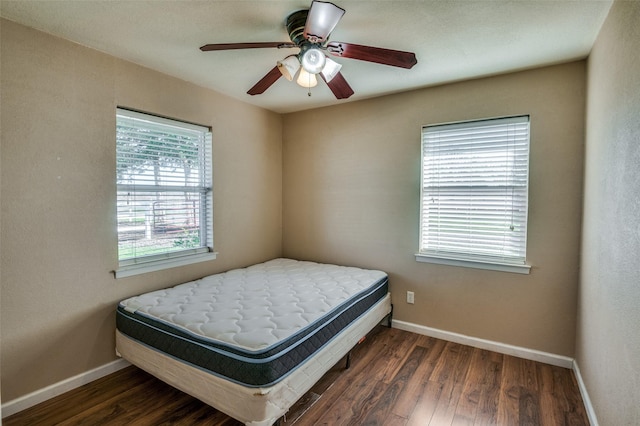 bedroom featuring ceiling fan and dark hardwood / wood-style flooring