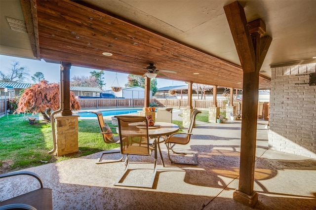 view of patio featuring ceiling fan and a fenced in pool